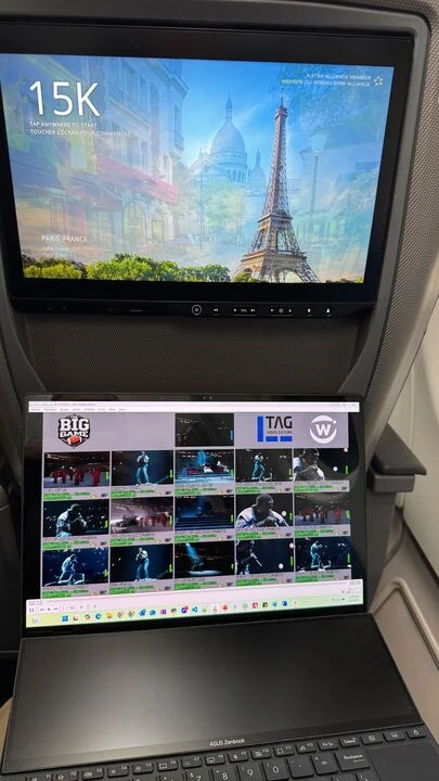 A laptop screen on a plane displaying the TAG multiviewer interface, monitoring real-time streaming latency during Super Bowl LIX powered by Witbe’s real-device monitoring technology.